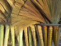 A pile of bamboo brooms in market for sale