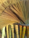 A pile of bamboo brooms in market for sale