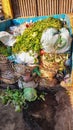 A pile of bamboo vegetable baskets and plastic bags in a rubbish dump at a traditional market