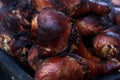 Barbecued turkey drumsticks on a grill at street fair
