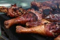 Barbecued turkey drumsticks on a grill at street fair