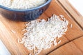 Pile of basmati rice grains on wooden background