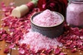 pile of bath salts with dried rose petals on wooden surface Royalty Free Stock Photo