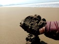 Pile of beach sand in hand