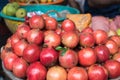 A pile of beautiful organic burgundy pomegranates