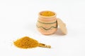 Pile of bee pollen, wooden scoop, glazed clay pot, lid. Royalty Free Stock Photo