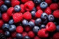 A pile of berries raspberries and blueberries