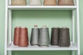 Pile of big colorful spools of yarn on shelving Royalty Free Stock Photo