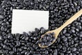 Pile black beans and note paper. Royalty Free Stock Photo