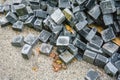 Pile of black natural stone cubes, outdoor pavement tiles. Broken road tiles