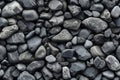 Pile of black pebble stones as background texture close up