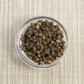 Pile of Black peppercorns Black pepper dried seeds on bamboo wooden background Royalty Free Stock Photo