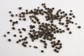 Pile of Black peppercorns Black pepper dried seeds on white textured background Royalty Free Stock Photo