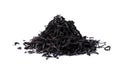 Pile of black tea leaves scattered on white table Royalty Free Stock Photo