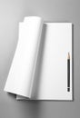 Pile of blank sheets of paper with curled upper page and pencil Royalty Free Stock Photo