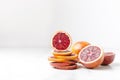 Pile of blood orange slices and halfs of it on the white table.Empty space for your design Royalty Free Stock Photo