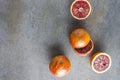 Top view of sicilian fruits.Whole and halves blood oranges on dark surface