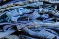 Pile of blue denim jeans. Background texture. Beauty and fashion concept