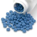 A pile of blue pills and medication bottle Royalty Free Stock Photo