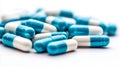A pile of blue and white pills on a white surface Royalty Free Stock Photo