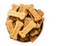 Pile of Bone shaped dog biscuits in food bowl. White background with copy space Royalty Free Stock Photo