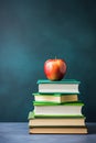 a pile of books with a fresh red apple on top Royalty Free Stock Photo