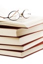 Pile of books with glasses over it Royalty Free Stock Photo