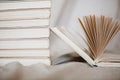 Pile of books with one open book lying near. Royalty Free Stock Photo