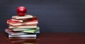 Pile of books and red apple on the desk Royalty Free Stock Photo