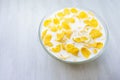 Pile in a bowl of milk of corn flakes white background Royalty Free Stock Photo