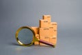 A pile of boxes and a magnifying glass. Concept search for goods and services. Tracking parcels. Quality control. Search Royalty Free Stock Photo