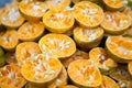 Pile of bright freshly squeezed orange rinds at an outdoor juice