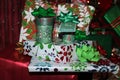 Pile of brightly colored wrapped Christmas presents with green bows with a Merry Christmas tag - selective focus with bokeh backgr Royalty Free Stock Photo