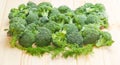 Pile of broccoli and branches dill on a wooden surface