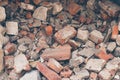 Pile of broken bricks, background. Texture, pattern, brick wall collapse. Destruction surface of building`s facade. Debris.