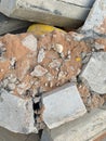 A pile of broken kerbstones covered with sand and concrete debris. Cracks and dislodged chunks highlight construction damage. The Royalty Free Stock Photo