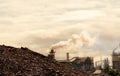 Pile of brown bottle for recycle in recycling factory. Glass waste for recycle. CO2 emissions. Carbon dioxide greenhouse gas Royalty Free Stock Photo