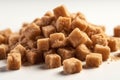 Pile of brown cane sugar cubes on black background. Eating too much sugar.