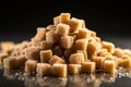 Pile of brown cane sugar cubes on black background