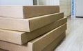 Pile of brown corrugated furniture box on laminate floor