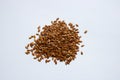 A pile of brown flax seed on a white background Royalty Free Stock Photo