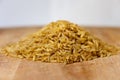 Pile of brown rice uncooked isolated and on wooden background Royalty Free Stock Photo
