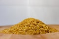 Pile of brown rice uncooked isolated and on wooden background Royalty Free Stock Photo