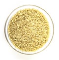 A pile of brown rice in a white bowl, isolated on a white background, top view Royalty Free Stock Photo