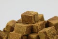 A pile of brown sugar cubes on white background Royalty Free Stock Photo