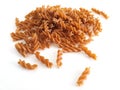 Pile of Bulk Whole Wheat Spelled Fusili Pasta on White Background Bunch of macaroni in the form of spirals Close up. Pasta and