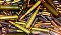 Pile of bullets with copper tips under a warm light. Close up of a lot of bullets. Gun violence in America. Ammunition