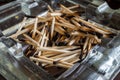 a pile of burnt matches in a glass ashtray