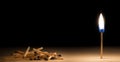 Pile of burnt matches laying down in front of one burnig match m Royalty Free Stock Photo