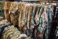 pile of camouflage-patterned clothing in a military store